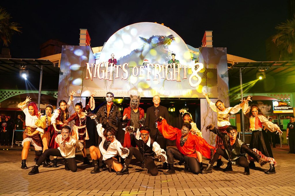 The Nights of Frights undead crew posing in front of the Nights of Fright entrance